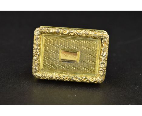 A GEORGE IV SILVER GILT VINAIGRETTE, of rectangular  form, front and back with engine turned decoration surrounded by a chase