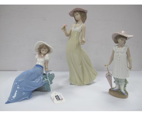 Three Nao Figurines, Autumn Showers, Girl Holding a Flower, Girl Sat on Rocks, (plus boxes). (3)