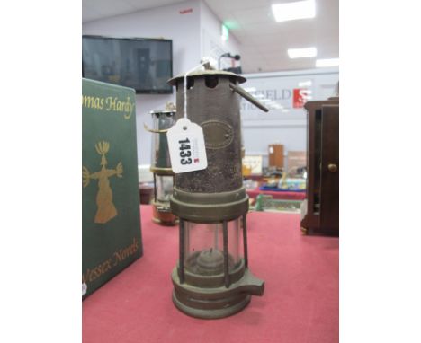 Miners Lamp E.Thomas &amp; Williams of Aberdare, iron upper and brass lower body 24.5cm high, with handle down.