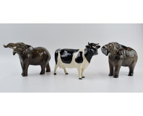 A pair of Beswick elephants (1 nip to tusk) and a Friesian cow (1 horn af) (3). One elephant is in good condition with no obv