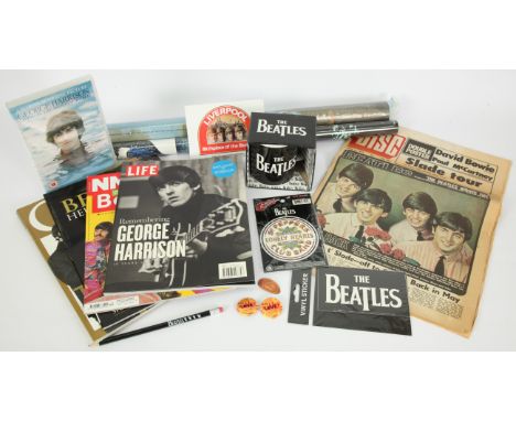 A collection of assorted memorabilia of The Beatles. Includes: Disc USA music paper from April 1973, 1 official mug with band