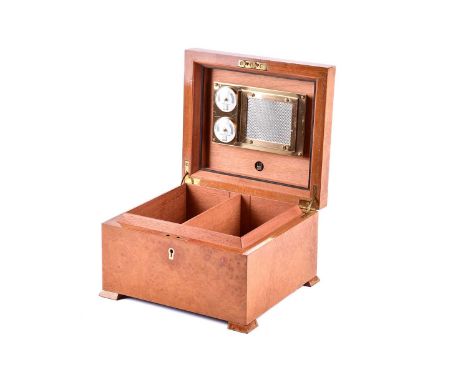 A Dunhill pale amboyna two-section caddy topped humidor box with fitted interior, and ivorine escutcheon, the whole supported