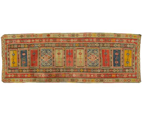 An old Turkish panelled ground kilim, each filled with sand spiders motifs within multiple borders, 1.4 m x 3.6 mPrivate esta