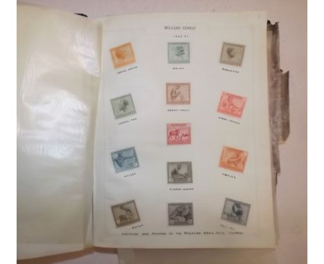 A Paragon postage stamp catalogue. well filled with early to mid period stamps, damp affected.