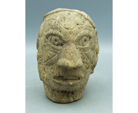 A rare Mound Builder stone pipe from Illinois. This fine Big Head type pipe is 6 in. high and depicts an individual wearing l