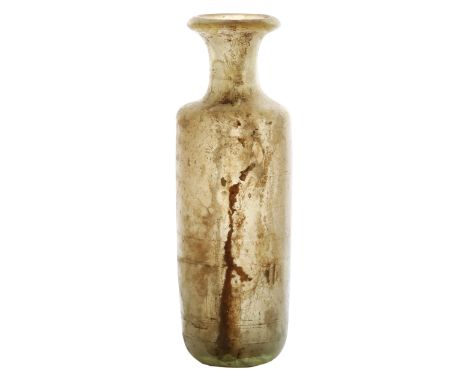 A Roman flask, 2nd - 3rd Century AD with a thick glass body of cylindrical form, and flared rim, 16cm tall