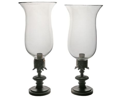 A pair of Regency candle lamps, circa 1820,&nbsp; the storm shades above the classical bronze bases, 29cm high, (2)