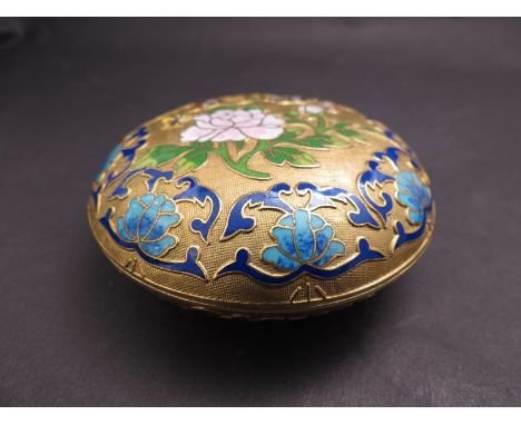 An enamelled and gilt circular trinket box decorated with flowers and butterflies 