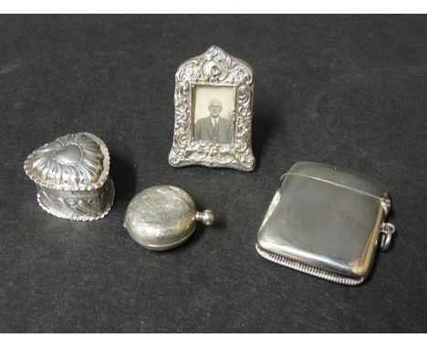 A silver sovereign case, dented, George Unite silver vesta, monogrammed, silver heart shaped trinket box and silver miniature