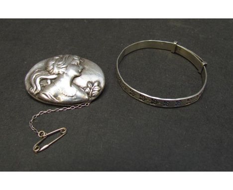 A silver oval brooch depicting bust of female marked 925 and a silver bangle marked 925