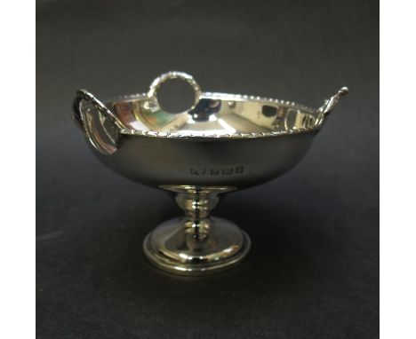 A silver pedestal bon bon dish with three cut away handles with swag detail, Birmingham 1918, makers mark rubbed, 64g
