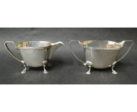 A Mappin & Webb silver twin handled sucrier, shell rim, raised on four shell and scroll feet, Sheffield 1931, dented, uneven 