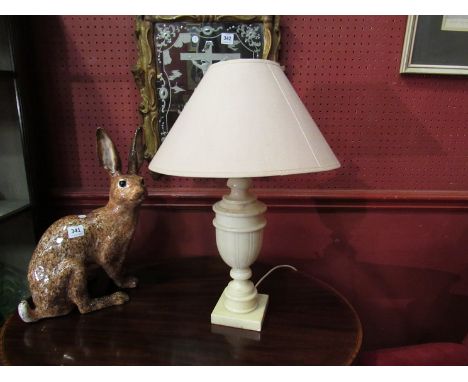 A cream alabaster table lamp with cream shade