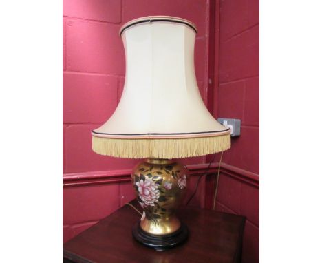 A 20th Century gilt ginger jar form ceramic lamp decorated with flowers, with shade
