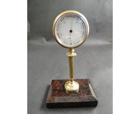 A desk standing aneroid barometer/thermometer on rouge marble base 