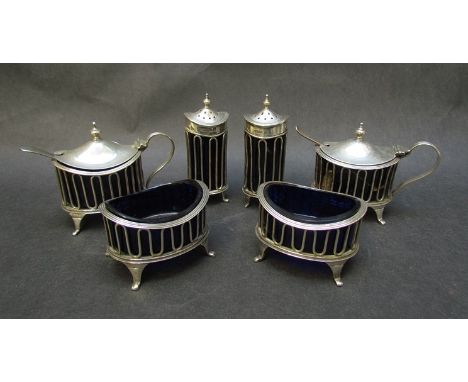 A T&E Co Ltd. six piece silver cruet set comprising two salts, two  mustards and two pepperettes all with blue glass liners (