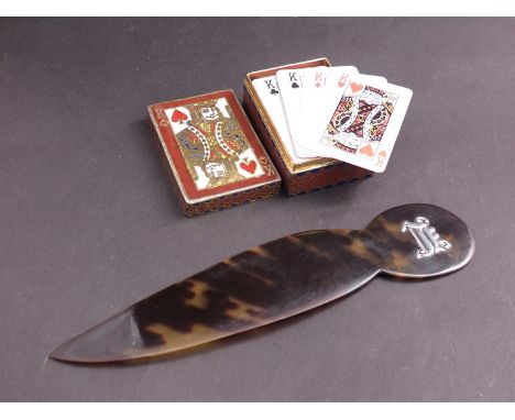 A tortoiseshell page turner and enamelled miniature playing card box with cards 