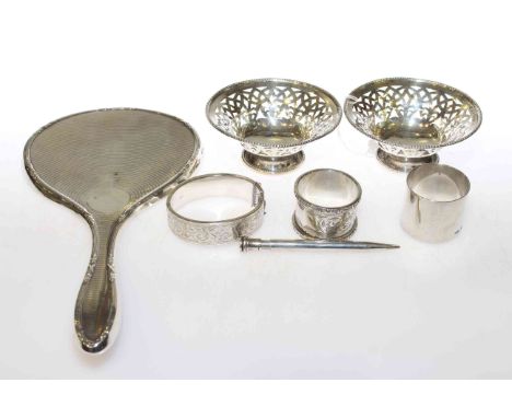 Pair of silver pierced bowls, two silver napkin rings, silver bangle, silver pencil and silver mirror (7)
