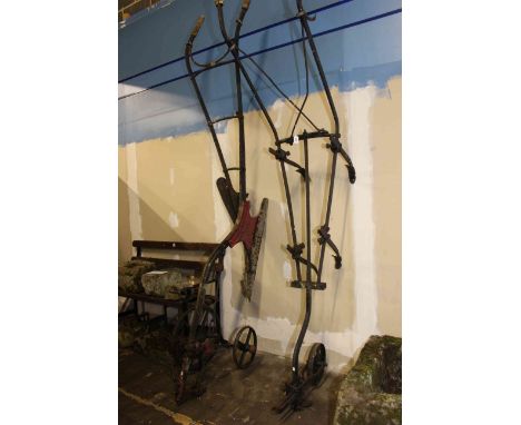 Two vintage cast farming ploughs