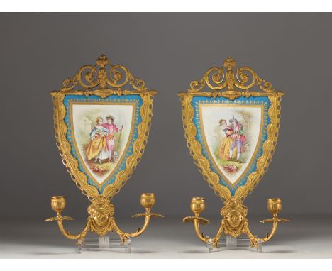 A pair of sconces in Sevres porcelain with romantic decor and chased ormolu mounts. Sevres mark with crossed L's A in the cen