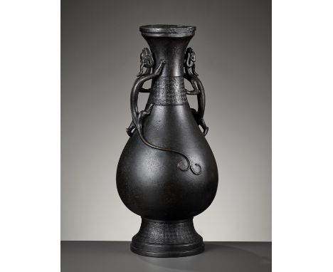 A LARGE ARCHAISTIC 'CHILONG' BRONZE VASE, 17TH-18TH CENTURYChina. Heavily cast, the baluster body supported on a stepped spre