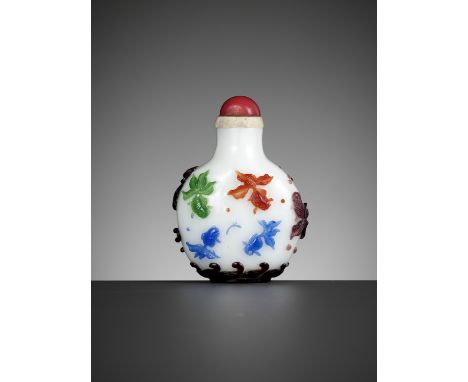 A FOUR-COLOR OVERLAY 'CELESTIAL EYE' GLASS SNUFF BOTTLE, QING DYNASTYChina, 19th century. Of compressed spherical form, risin