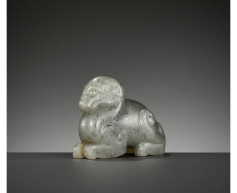 A GRAY JADE FIGURE OF A MYTHICAL BEAST, 17TH CENTURYChina. The recumbent beast carved with its feet tucked under the body, th