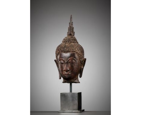 A BRONZE HEAD OF BUDDHA, SUKHOTHAIThailand, 15th-16th century. Finely cast, his serene face with heavy-lidded downcast eyes b
