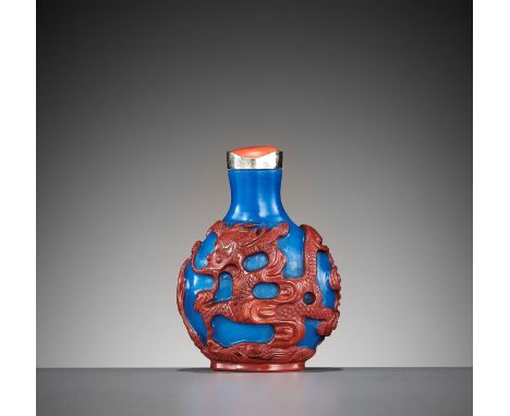 A CINNABAR-RED OVERLAY BLUE GLASS 'DRAGON' SNUFF BOTTLE, 1780-1860China. Of compressed globular form, rising from an oval foo