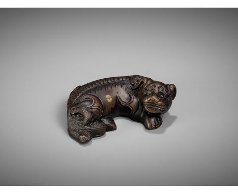 A BRONZE 'BUDDHIST LION' WEIGHT, MING DYNASTYChina, 1368-1644. Well cast in the form of a recumbent beast with legs tucked ne
