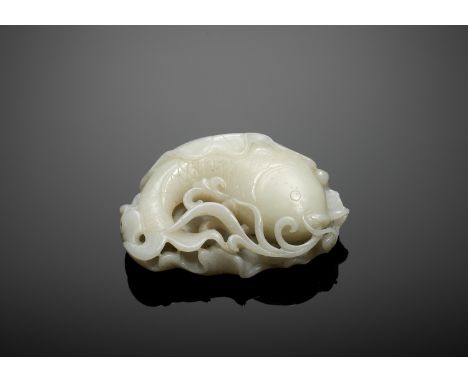 A WHITE JADE 'CARP IN LOTUS' PENDANT, QING DYNASTYChina, 1644-1912. Naturalistically carved and pierced as a carp emerging fr