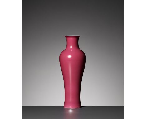 A PUCE-ENAMELED BALUSTER VASE, QING DYNASTYChina, 1644-1912. Delicately potted, rising from a spreading foot to a waisted nec