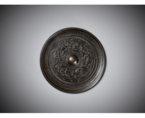 A 'MYTHICAL BEASTS' BRONZE MIRROR, HAN DYNASTYChina, 206 BC to 220 AD. The central pierced knob set within concentric circles