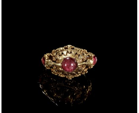 A RUBY-SET GOLD 'FLOWER AND BIRD' PRIEST'S RINGIndonesia, Bali, 19th to early 20th century. The gold ring with a conical beze