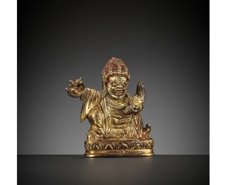 A BRONZE FIGURE OF MAHAKALA, 17TH-18TH CENTURYTibet. Mahakala standing atop a prostrate figure on a lotus base, his right han