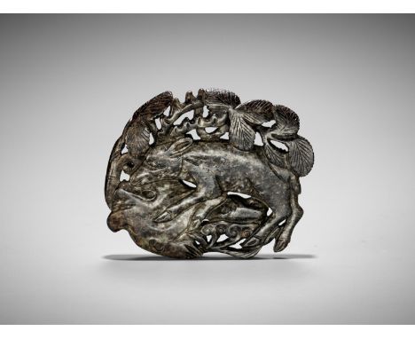 A BLACK JADE 'DEER' PLAQUE, JIN TO YUAN DYNASTYChina, 13th-14th century. Of flattened form, finely carved in openwork to depi