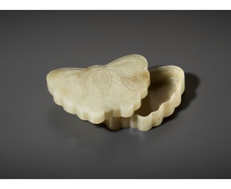 A PALE CELADON JADE 'BUTTERFLY' BOX AND COVER, LATE QING DYNASTYChina, 19th century. The flat box is formed as a butterfly wi