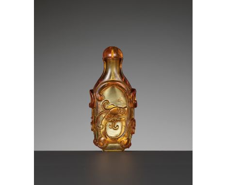 AN AMBER GLASS 'CHILONG' SNUFF BOTTLE, 1750-1850China. Of flattened form, the ovoid body supported on a flat oval foot and ri