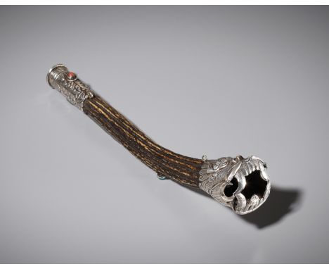A SILVER AND STAG ANTLER 'MAKARA' FLUTE, KANGLING, TIBET, 19TH CENTURYThe stag antler trumpet with a silver repousse mouthpie