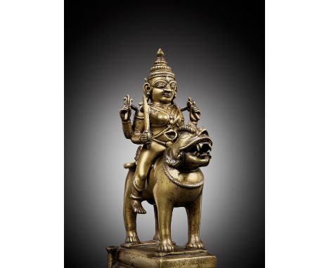 A BRONZE FIGURE OF DURGA RIDING A LION, INDIA, 15TH CENTURYThe seated goddess mounted on the separately cast lion standing fo