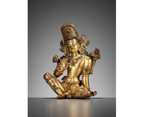 A GILT COPPER ALLOY FIGURE OF INDRA, NEPAL, 15TH-17TH CENTURYSeated in rajalilasana, leaning on his left hand, the left shoul