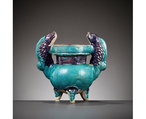 A FAHUA 'DOUBLE FISH' TRIPOD CENSER, MING DYNASTYChina, 1368-1644. Raised on three supports, the body flanked by two large fi