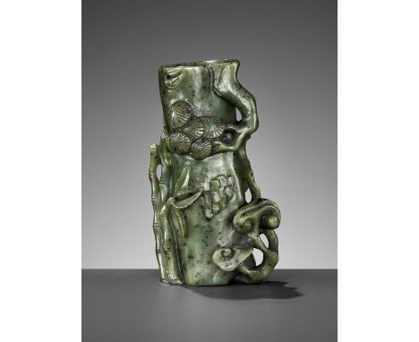 A SPINACH GREEN JADE 'PINE, LINGZHI AND BAMBOO' VASE, 18TH CENTURYChina. Fashioned in the form of a hollowed-out tree trunk i