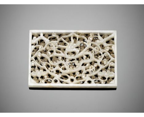 A RECTANGULAR WHITE JADE 'DRAGON' PLAQUE, MING DYNASTYChina, 1368-1644. The plaque is intricately carved and pierced to depic