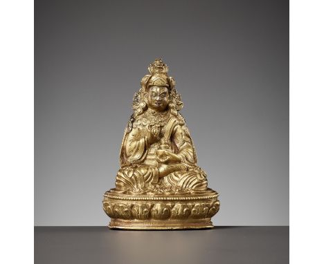 A GILT COPPER ALLOY FIGURE OF PADMASAMBHAVA, BUTHAN18th-19th century. Seated in dhyanasana atop a finely incised lotus base w