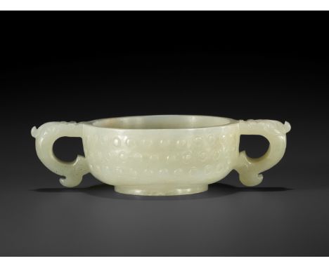 A PALE CELADON TWO-HANDLED JADE CUP, MING DYNASTYChina, 1368-1644. The rounded sides rising from a short straight foot, the s