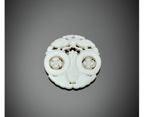 A WHITE JADE 'BUTTERFLY' PLAQUE, LATE QING TO REPUBLICChina, 1850-1949. Of circular form, carved in openwork as two confronti