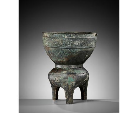 A BRONZE TRIPOD STEAMER, YAN, WESTERN ZHOU DYNASTYChina, 1100-771 BC. Comprised of two parts, the lower vessel supported on t