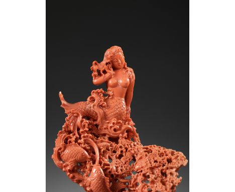 A FINELY CARVED CORAL GROUP OF A MERMAID AND FISH, 20TH CENTURYChina. Finely carved as a mermaid resting on a carp emerging f