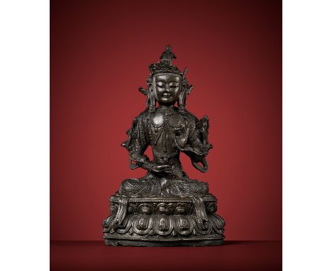 A BRONZE FIGURE OF AVALOKITESHVARA, MING DYNASTYChina, 1368-1644. Seated in dhyanasana atop a double lotus base with beaded e